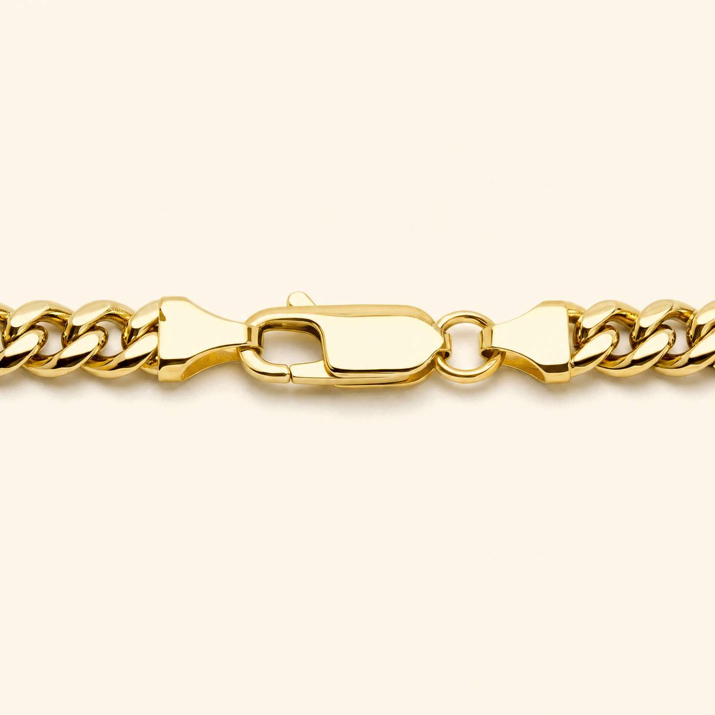 The chain coiled on a dark ground, links catching the light