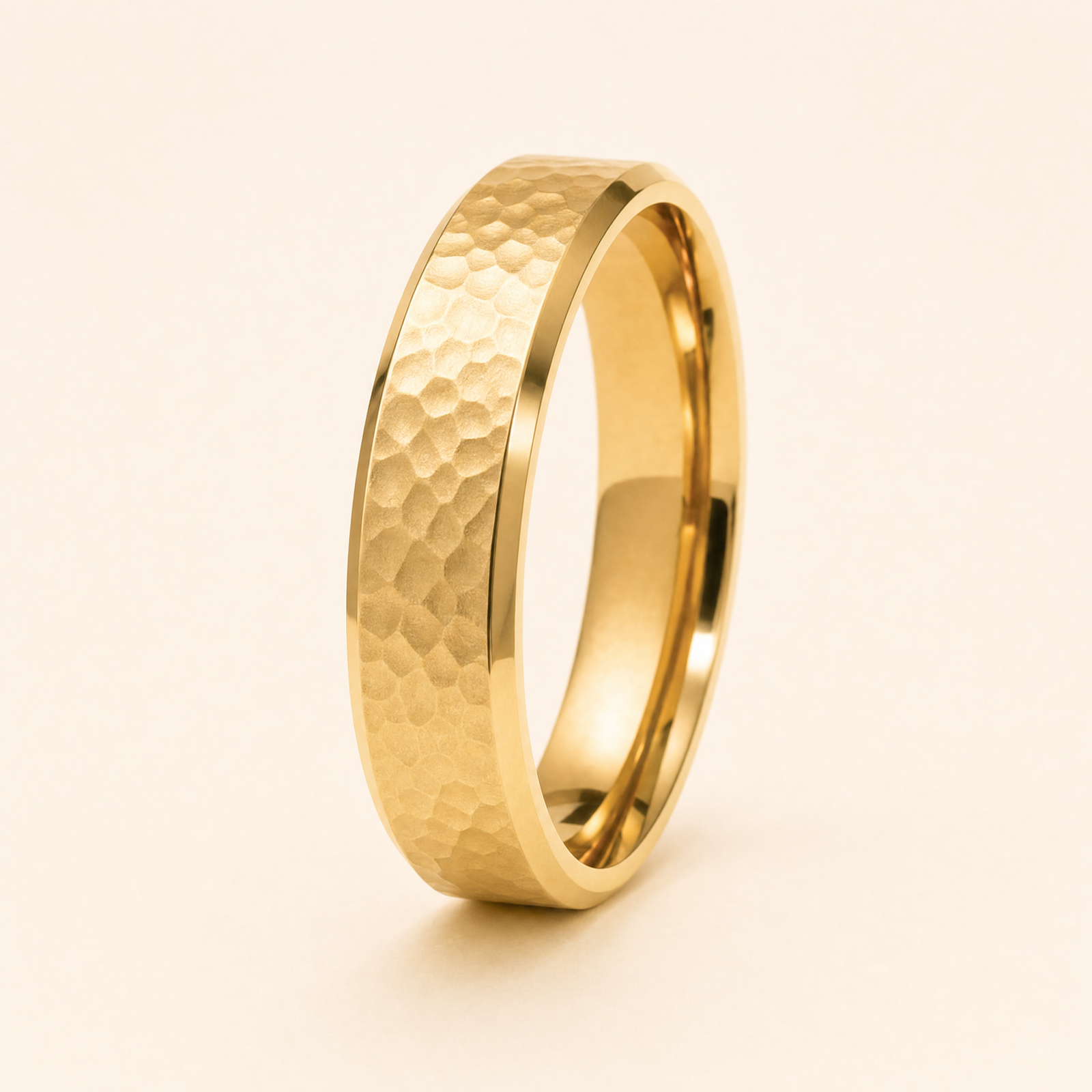 Gold · Hammered — men's 5mm beveled wedding band with hammered finish standing on seamless ivory