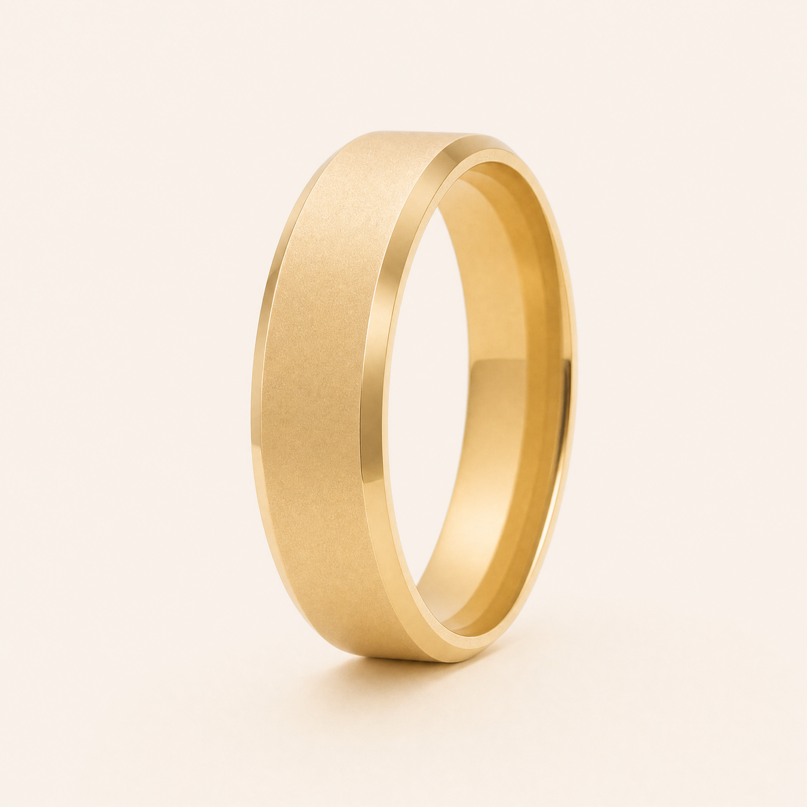 Gold · Ice matte — men's 5mm beveled wedding band with frosted ice matte finish standing on seamless ivory