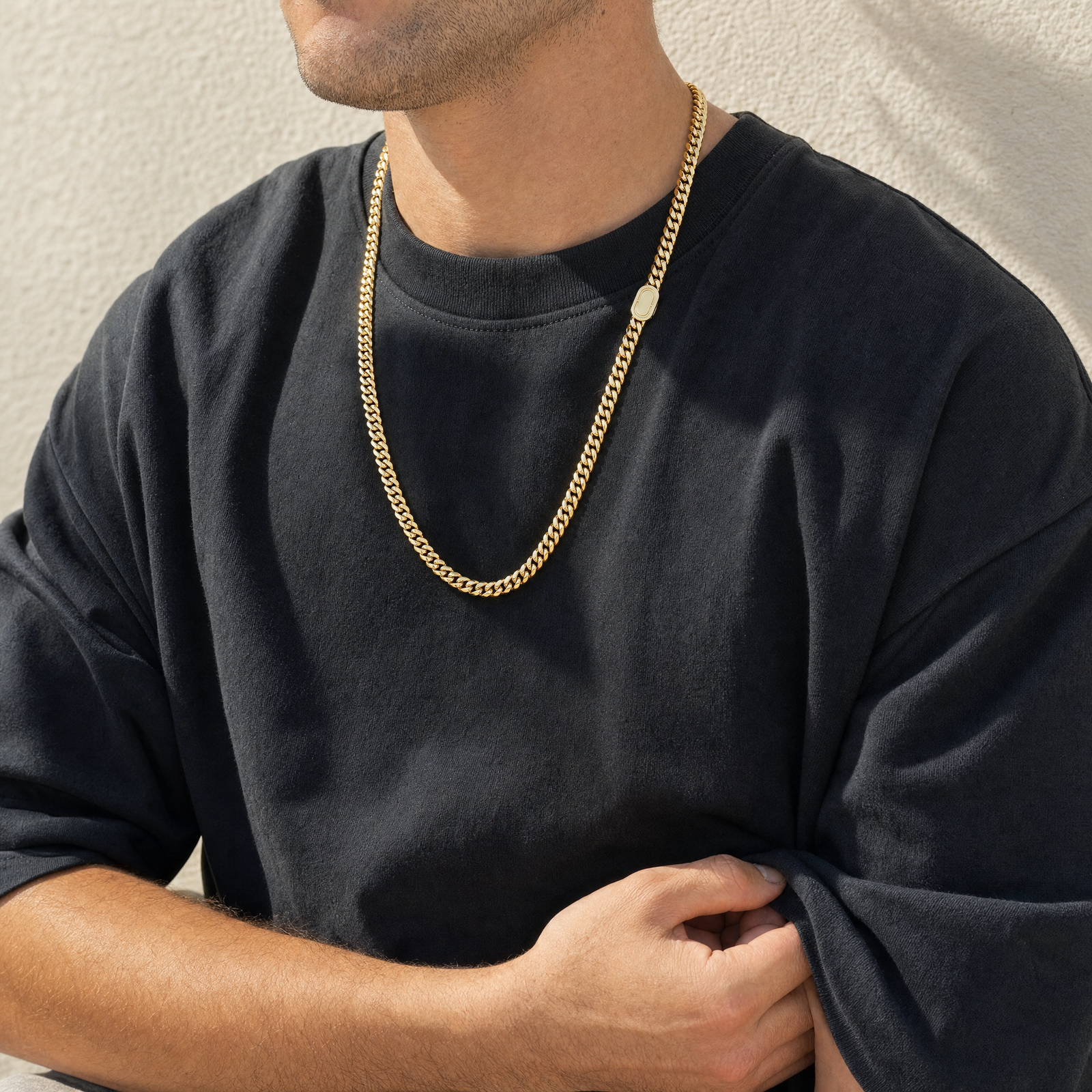 Man wearing the 8mm gold Cuban chain in warm daylight
