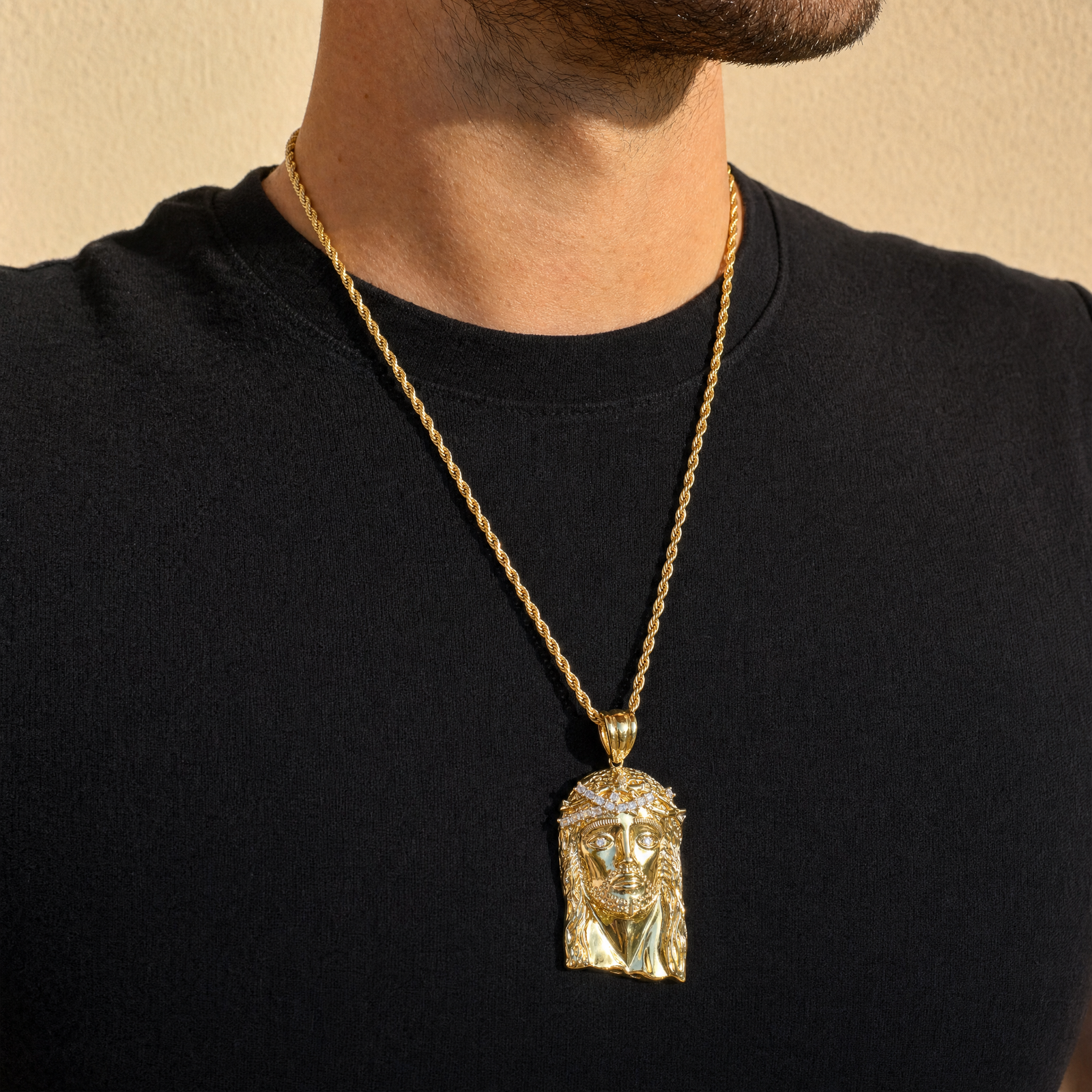 Man wearing the gold Jesus pendant in warm daylight