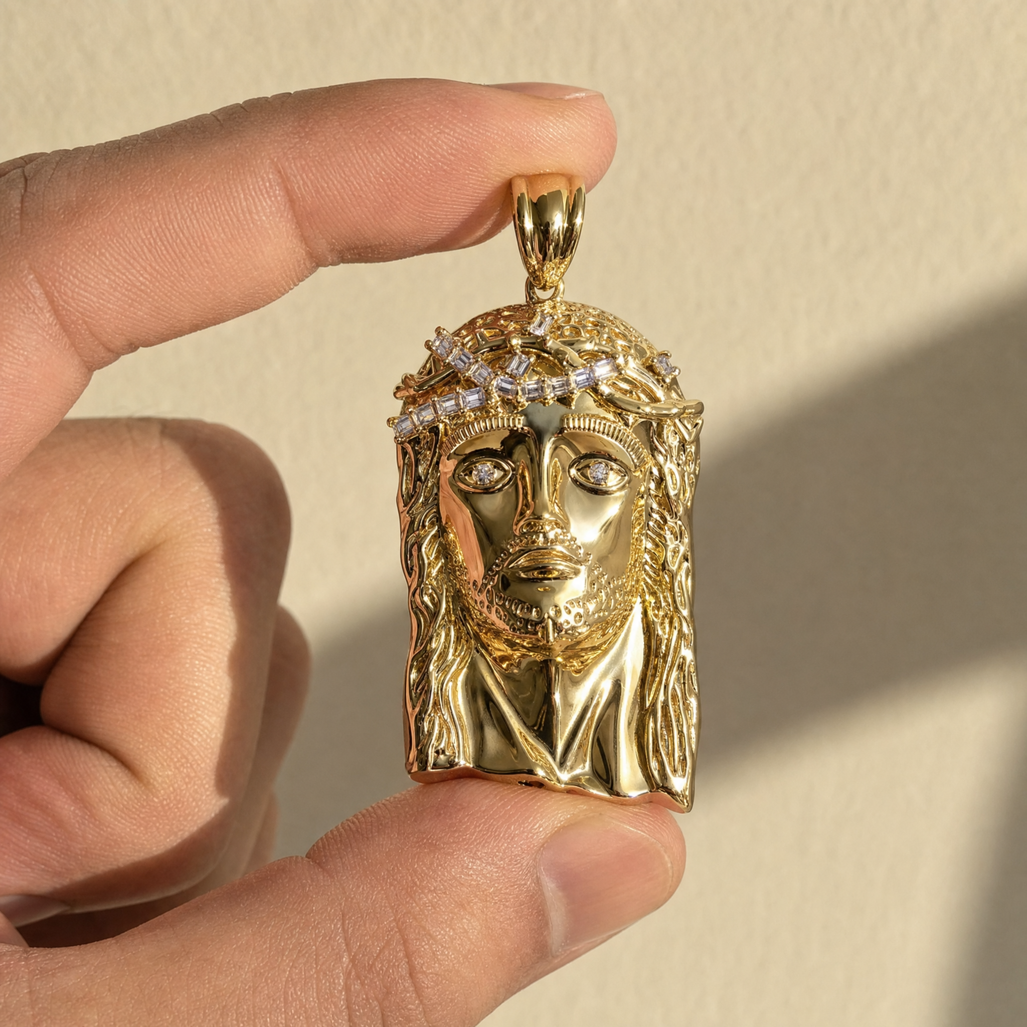 Jesus pendant held in hand showing its true size