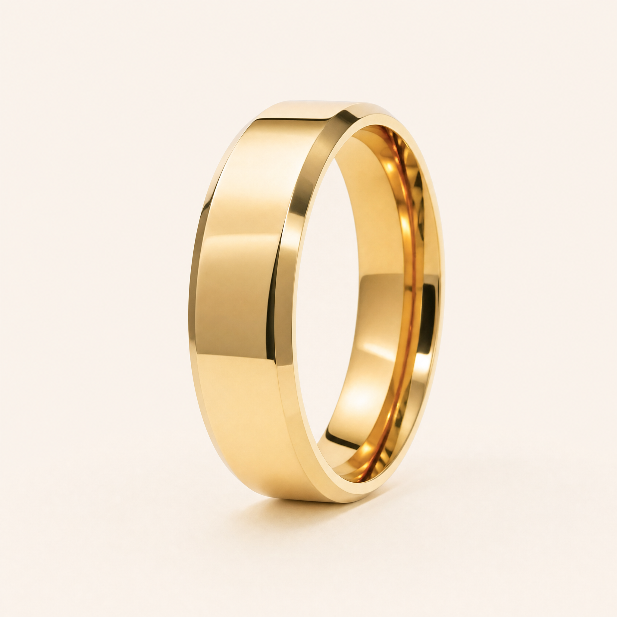 Men's 5mm beveled gold wedding band standing on seamless ivory