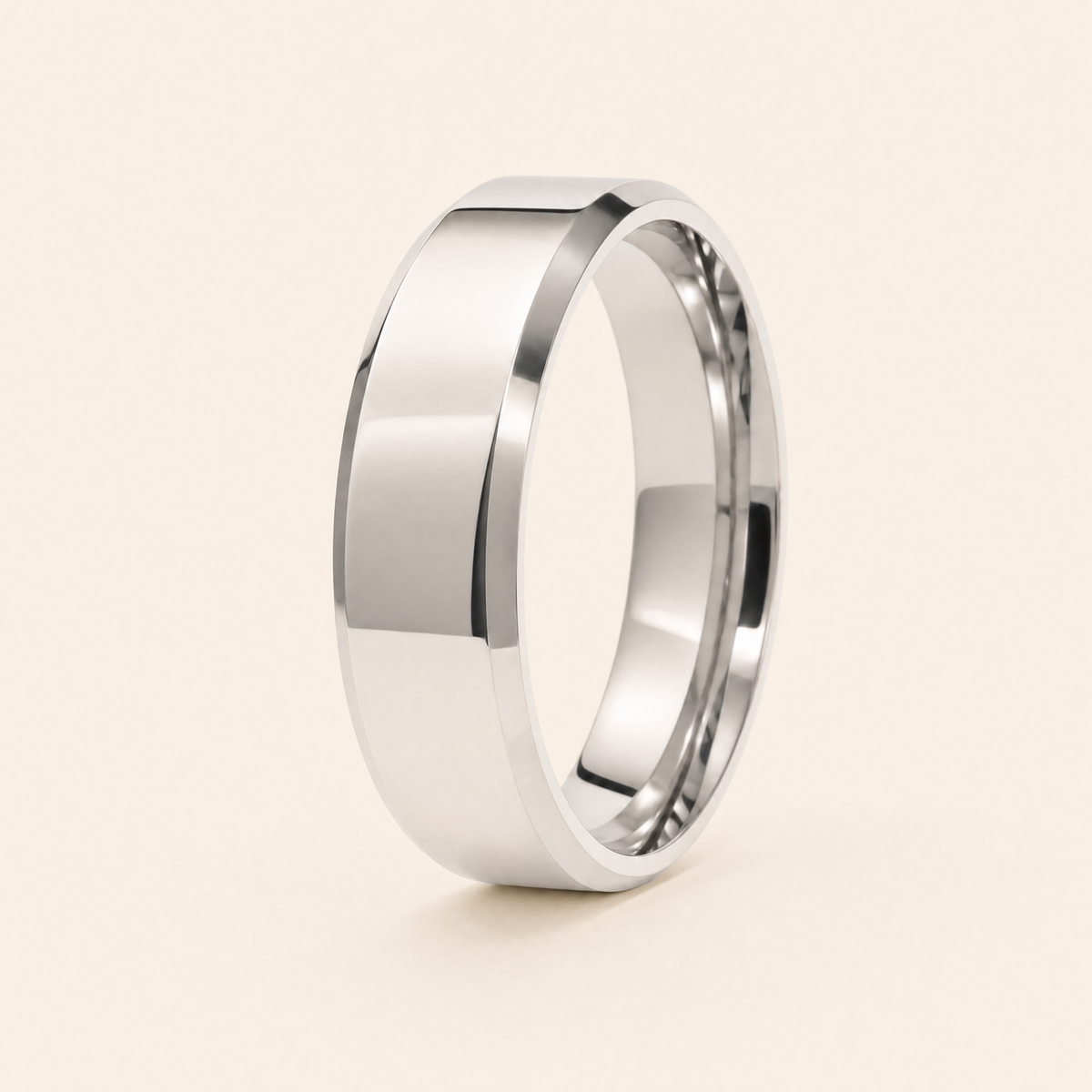 Silver — men's 5mm beveled silver wedding band standing on seamless ivory