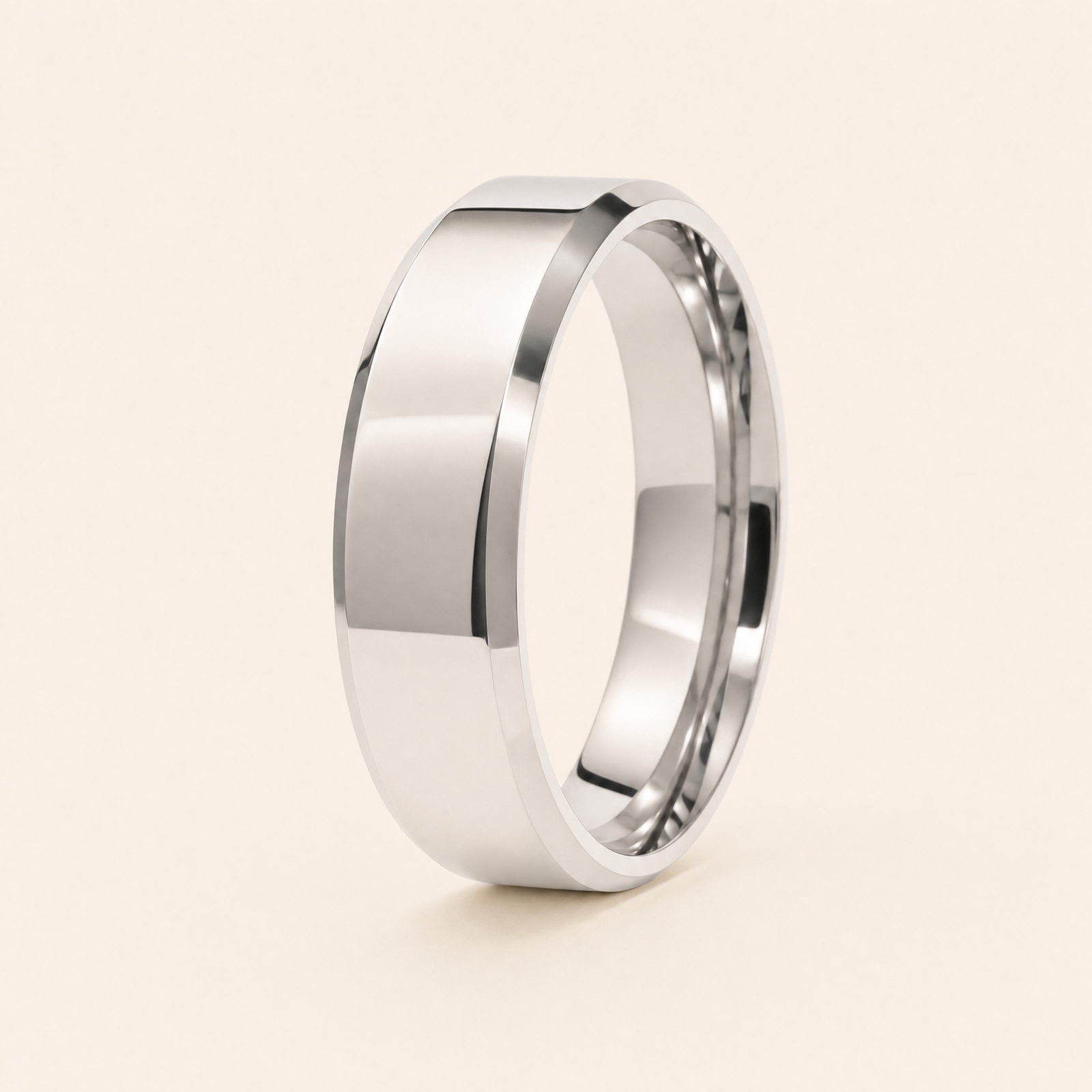 Silver — men's 5mm beveled silver wedding band standing on seamless ivory