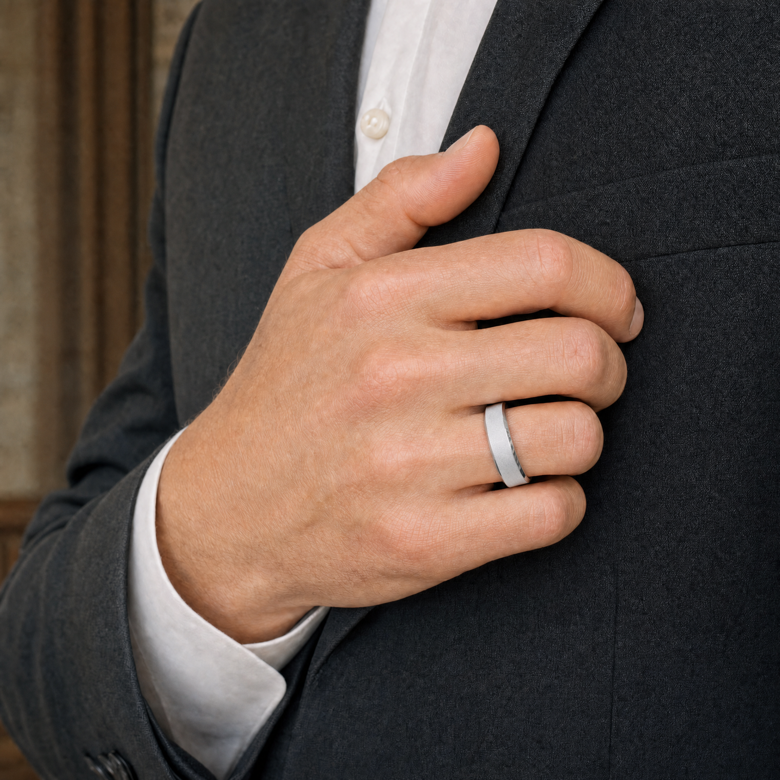 Silver · Ice matte — men's 5mm beveled frosted ice matte silver wedding band, worn on the hand against a charcoal suit