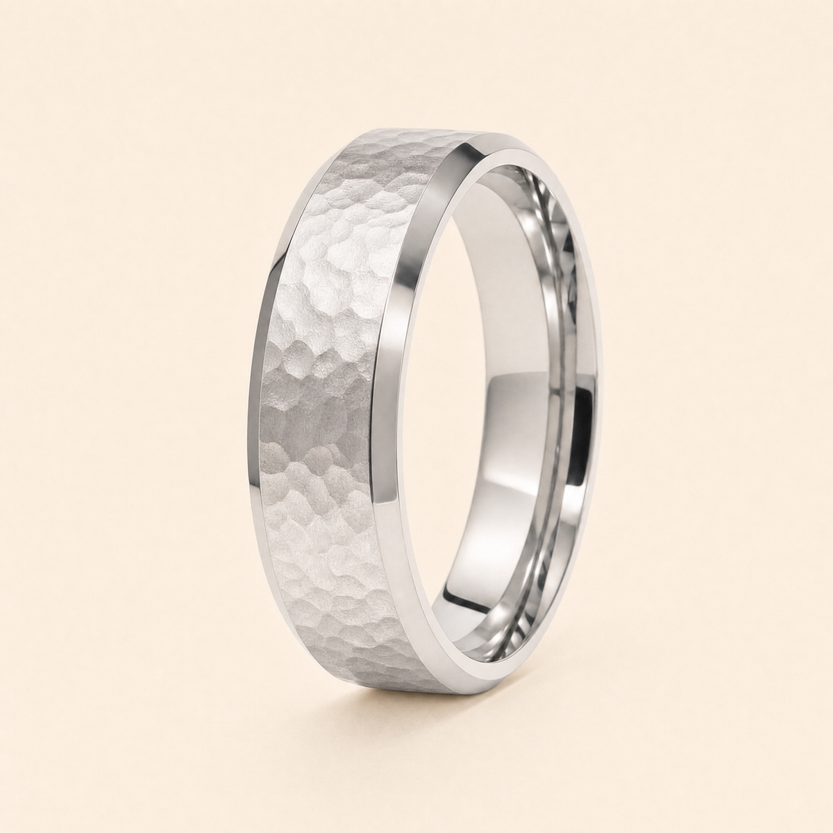 Silver · Hammered — men's 5mm beveled wedding band with hammered finish standing on seamless ivory