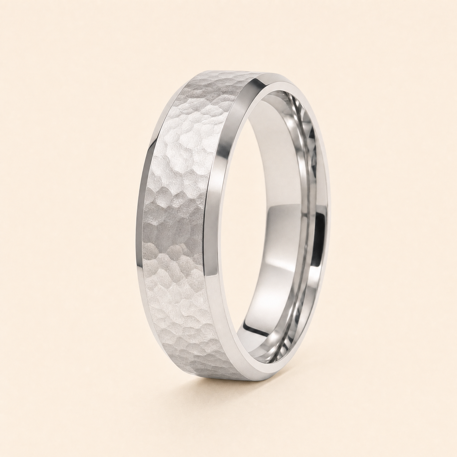 Silver · Hammered — men's 5mm beveled wedding band with hammered finish standing on seamless ivory