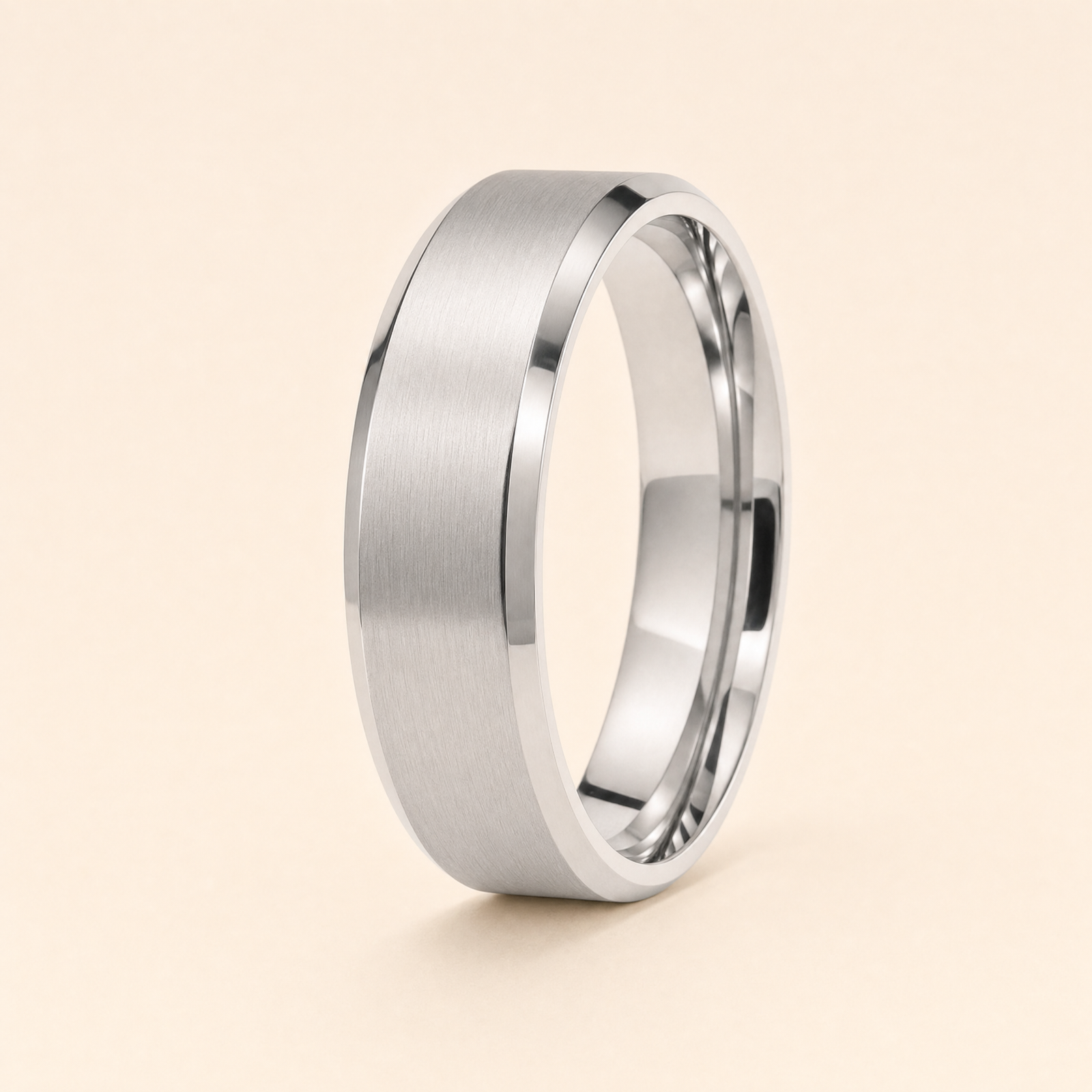 Silver · Matte — men's 5mm beveled wedding band with matte brushed finish standing on seamless ivory